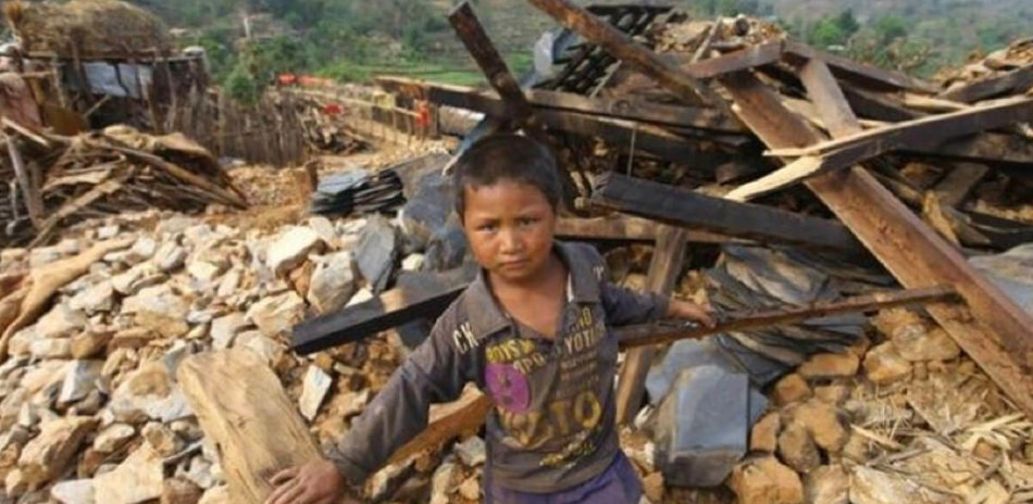 AFO Impact - Nepal - Boy in rubble from Gorkha Earthquake