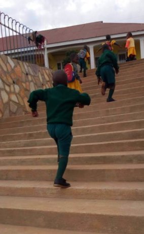 Kampala CPC children running up stairs