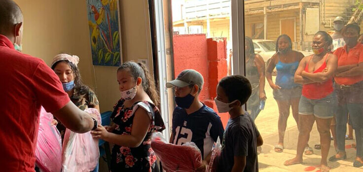 AFO Impact - Belize passing out backpacks